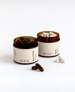 AVEA Booster and NMN jars with capsules visible, shown in amber containers on a light background.